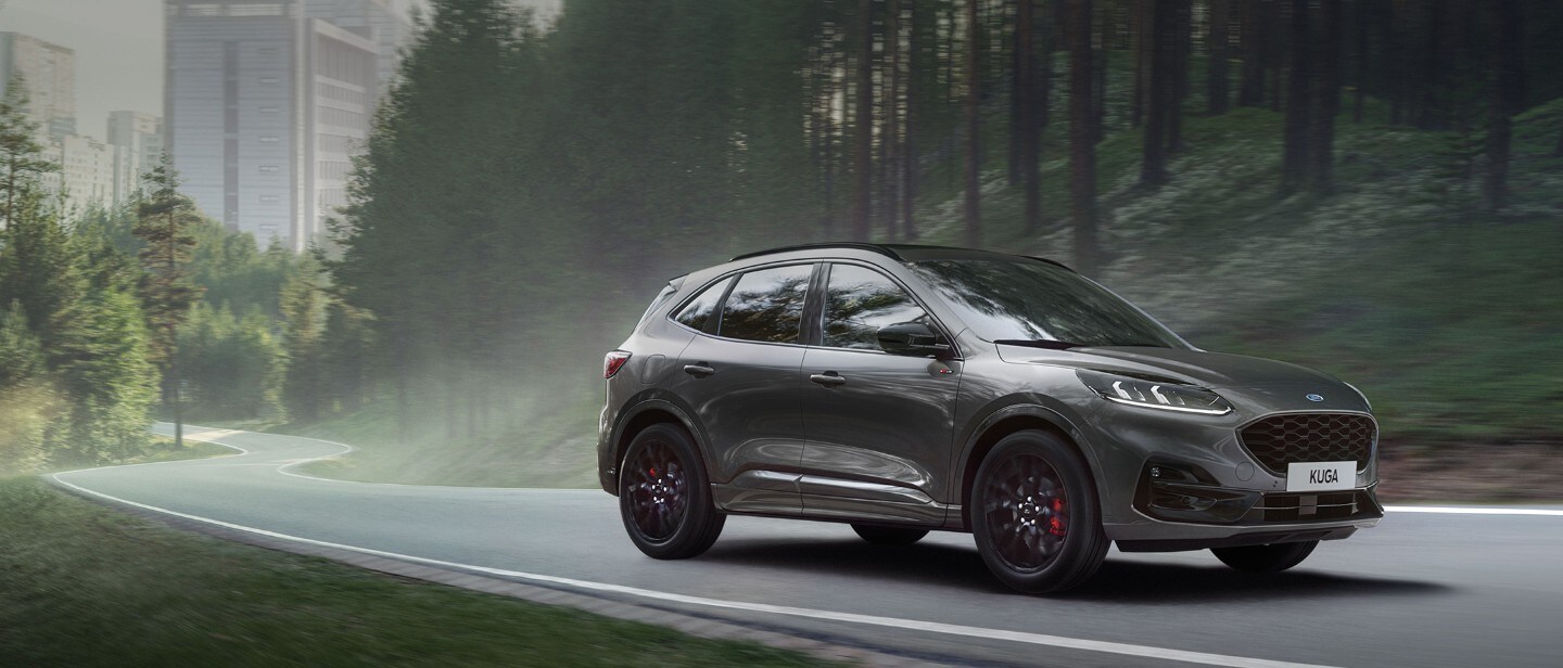 Red Kuga charging in front of a house