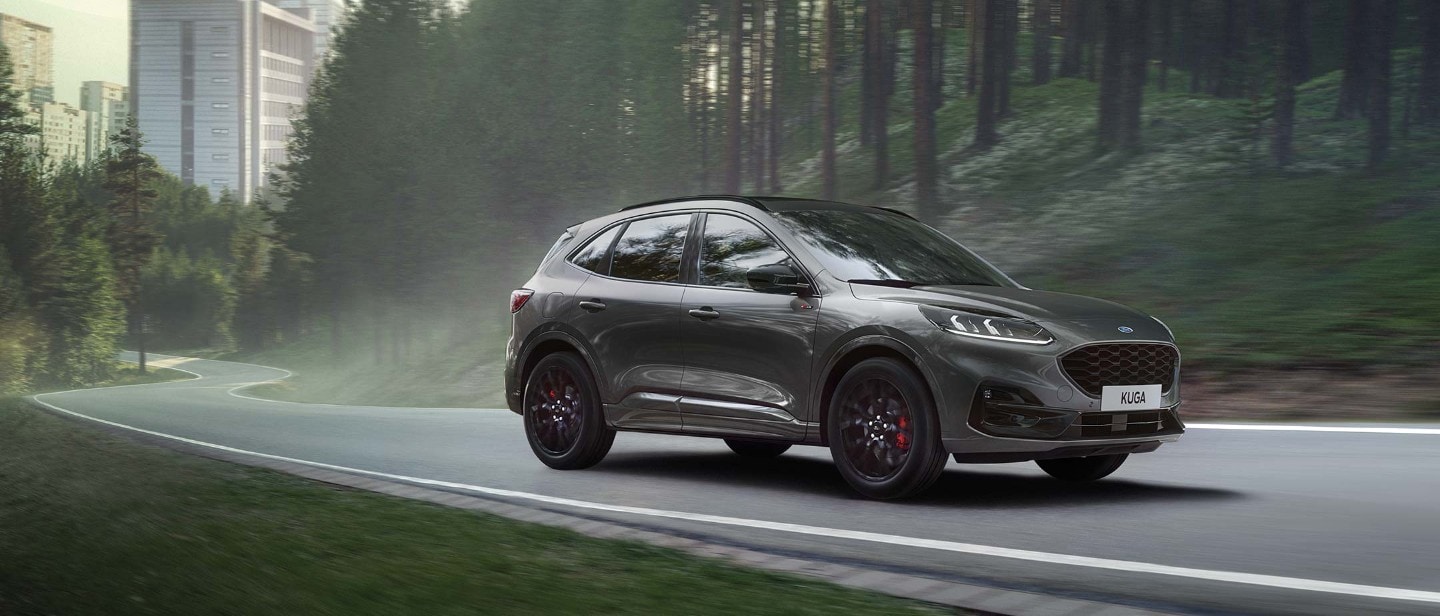 Red Kuga charging in front of a house