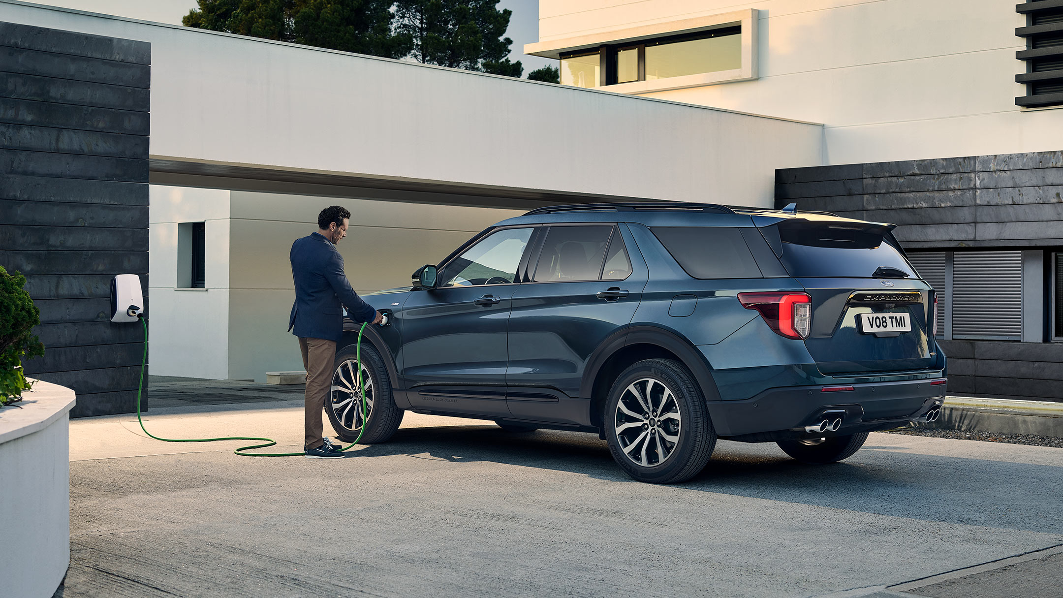 Ford Explorer parking and charging next to the building