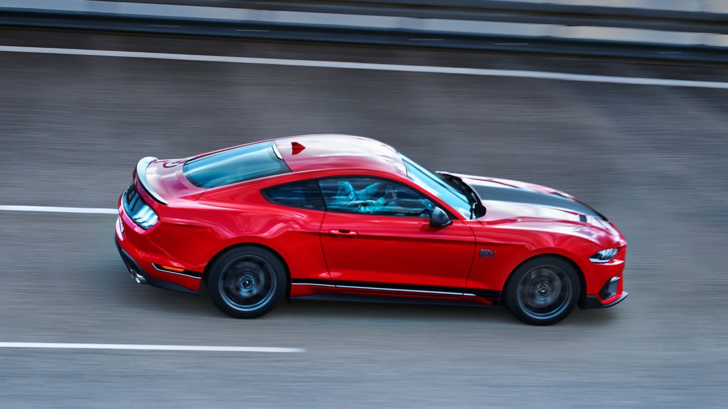 All-New Ford Mustang Mach 1 side view driving on a racing track.