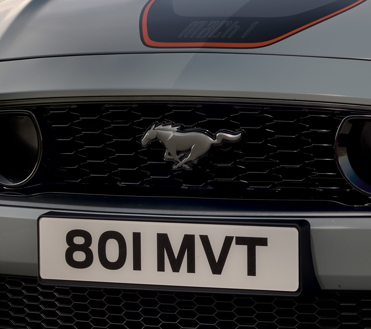 Ford Mustang Mach 1 front grill badge closeup.