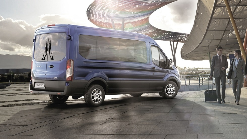 Blue Ford Transit Minibus parked outside airport