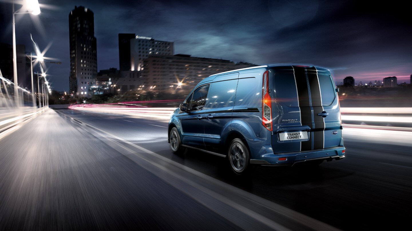 Ford Transit Connect parked next to modern building