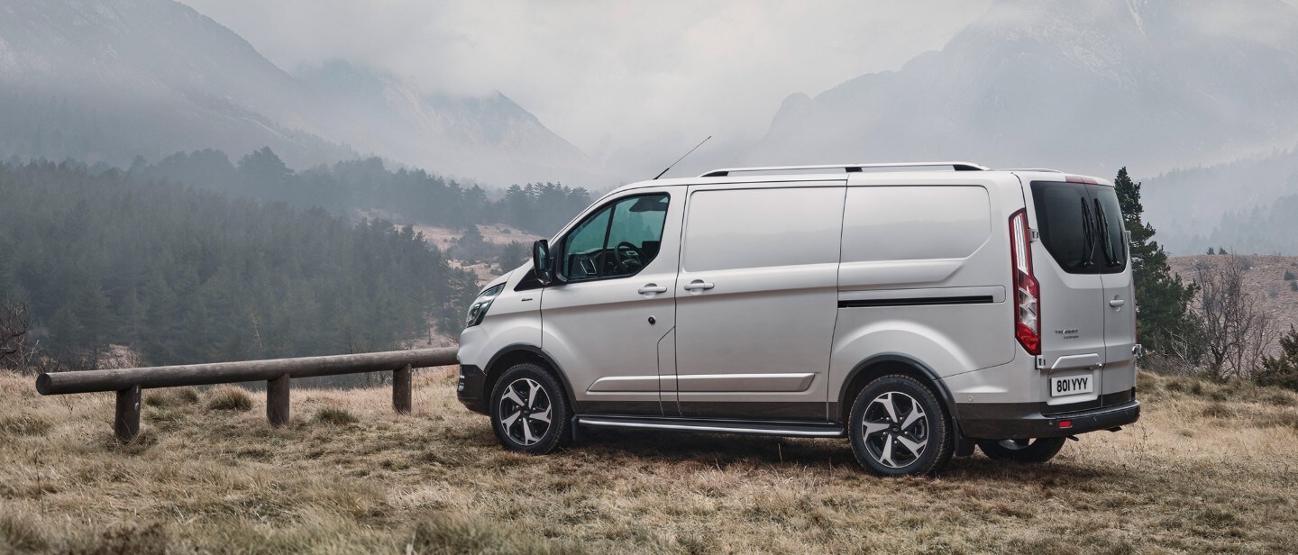 Transit Custom parked outside with mountains view