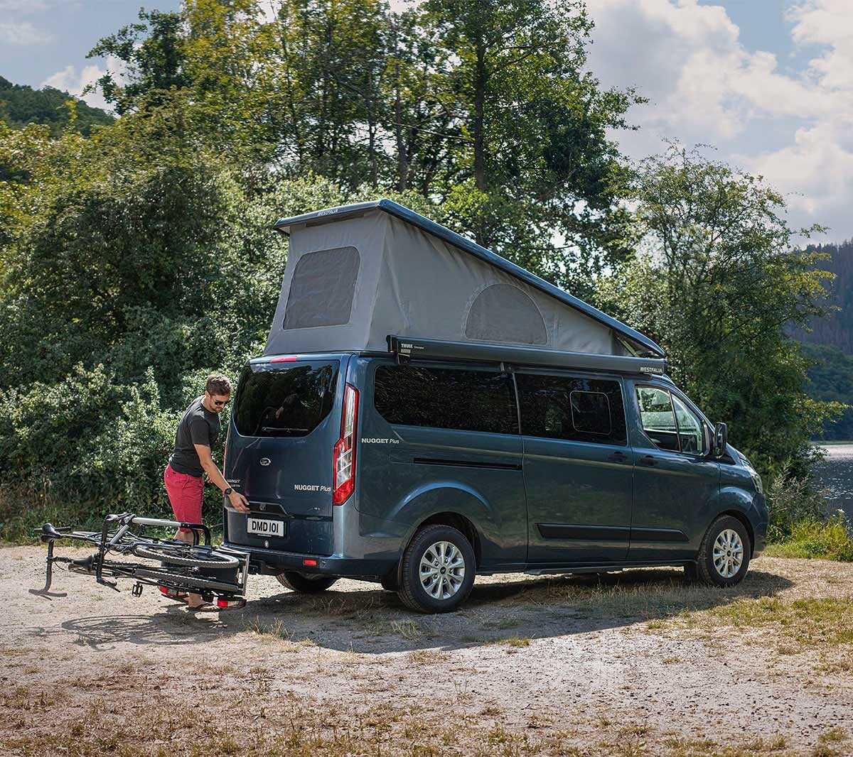 New Grey Ford Transit Custom Nugget rear view parked by lake