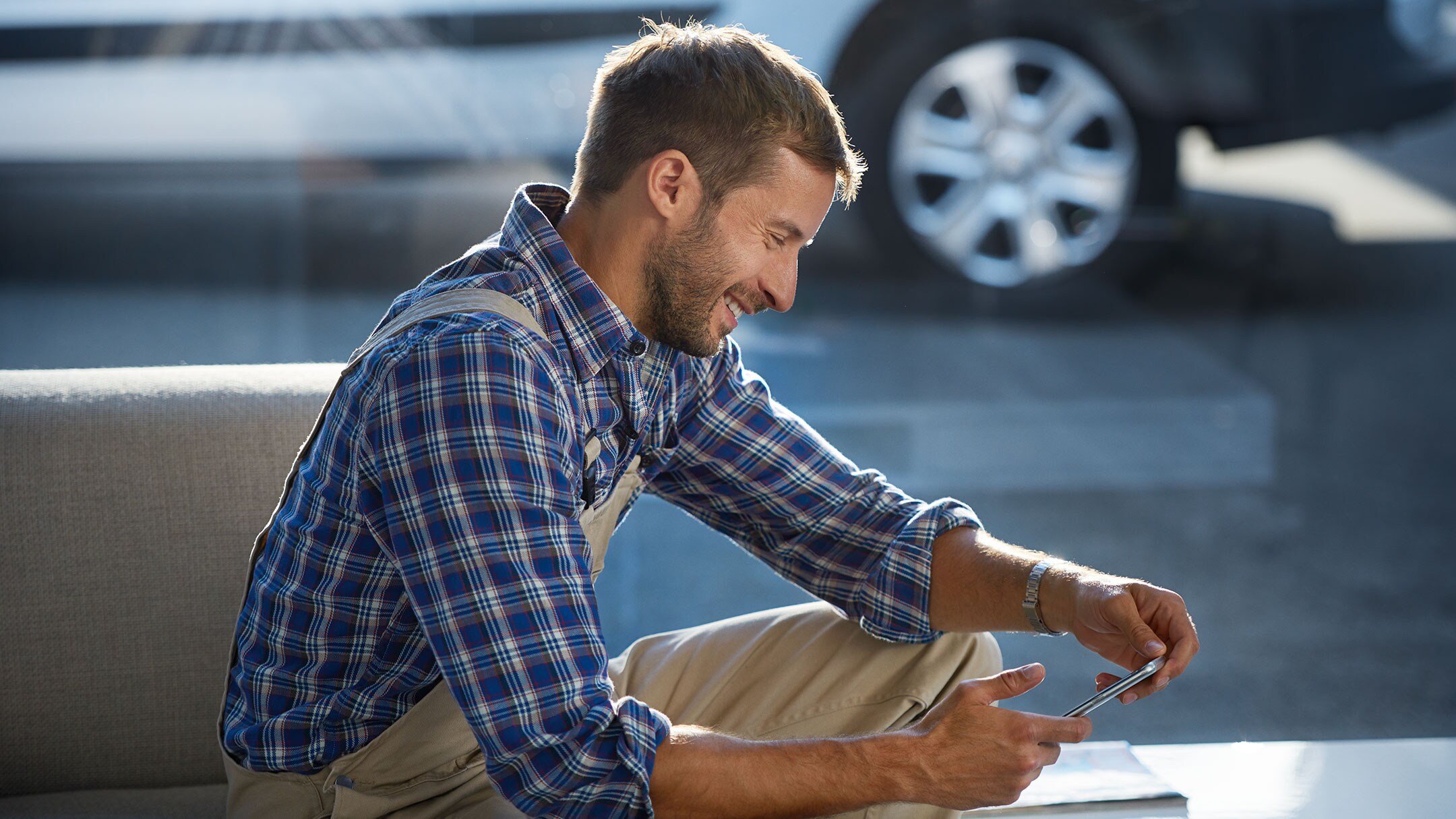man looking down at phone smiling man looking down at phone smiling