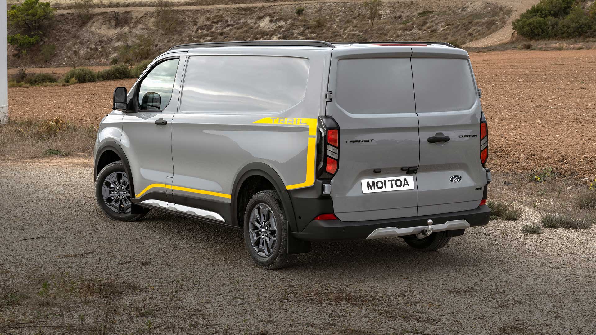 Widok z tyłu na szarego vana Ford Transit Custom Trail.
