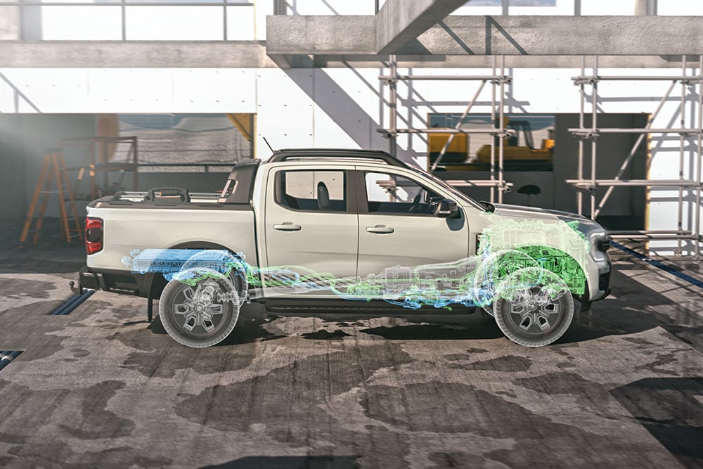 Transparent view of Ford PHEV's hybrid system, parked at a construction site with scaffolding in the background.