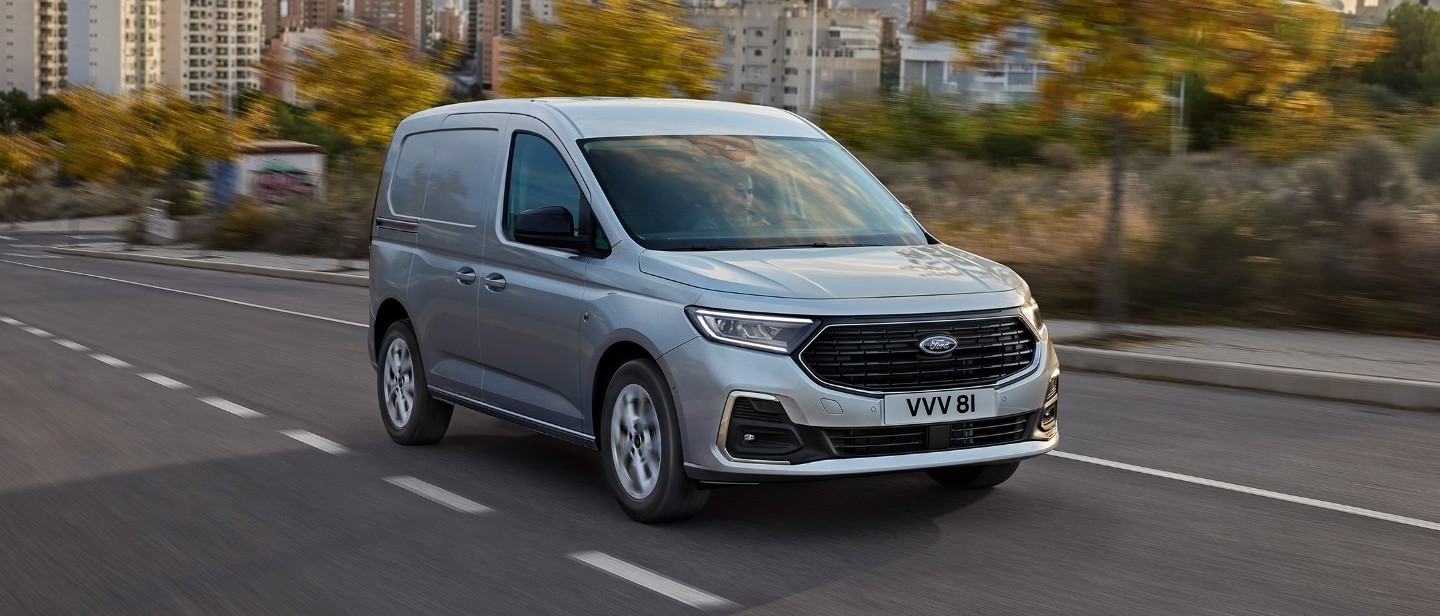 Silver Ford Transit Connect driving on the road