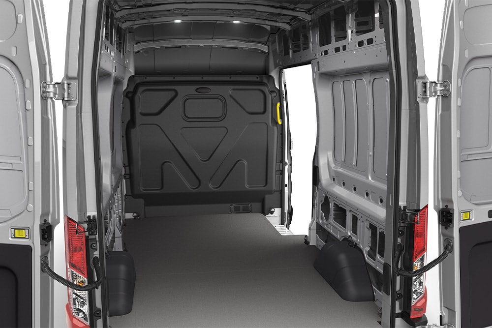 Interior view of an empty cargo area of a Ford Transit Van.