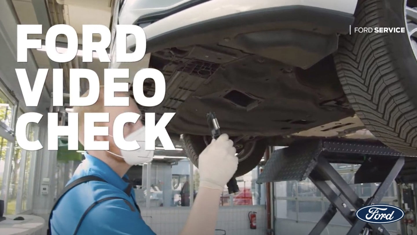 Ford Service Engineer checking under vehicle chassis